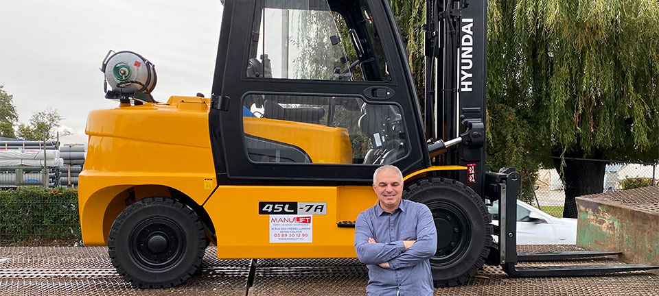 salim mankour from new dealer manulift standing for an hyundai truck