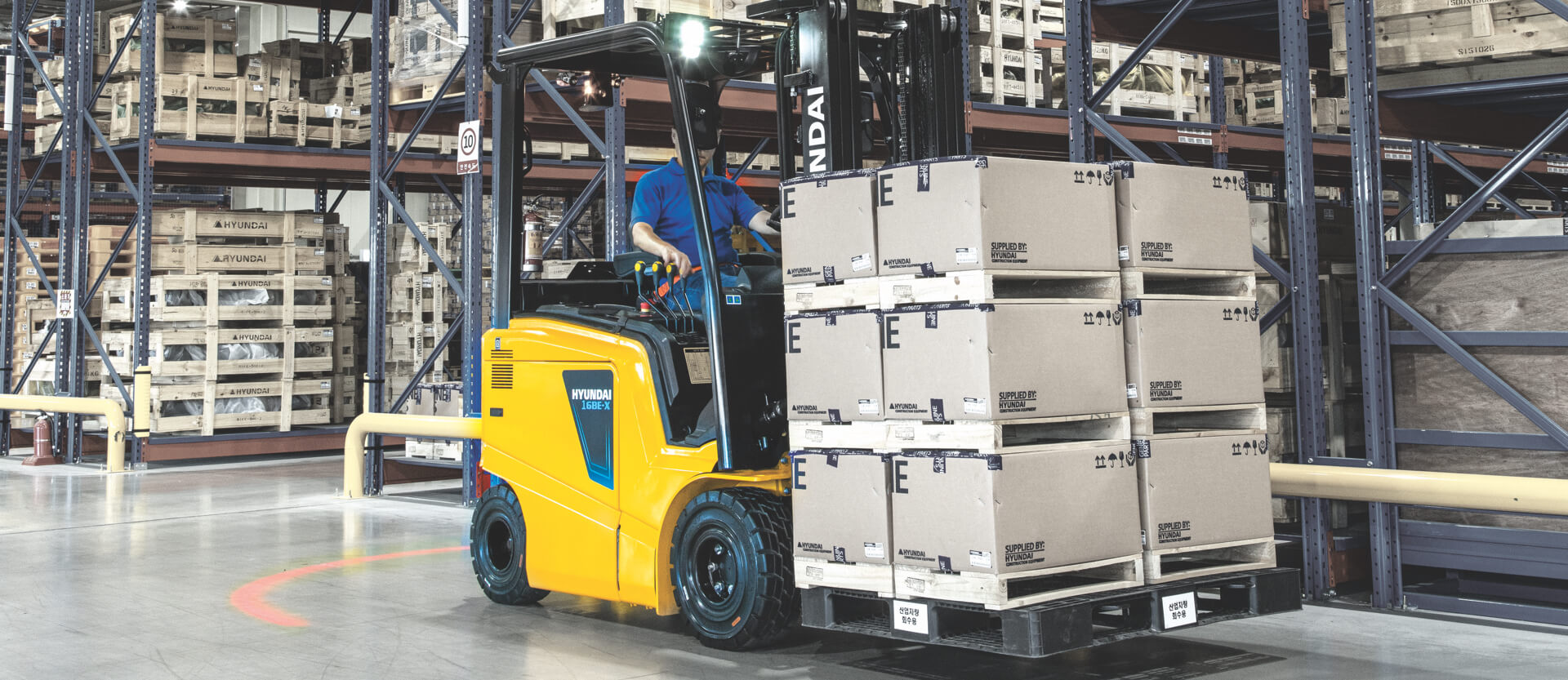 HD Hyundai XiteSolution Electric Forklift transporting pallet